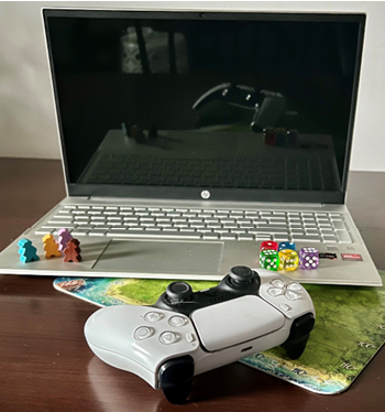 image of laptop, controller, and game pieces